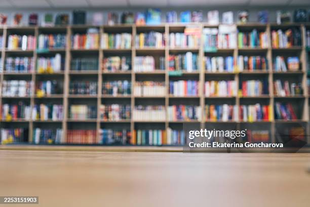 bookshelves with blurred background in bookstore or library - book shop stock pictures, royalty-free photos & images