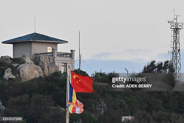 The Chinese flag is seen on Pingtan island, the closest point to Taiwan, in eastern China's Fujian province on December 29, 2025. China launched...