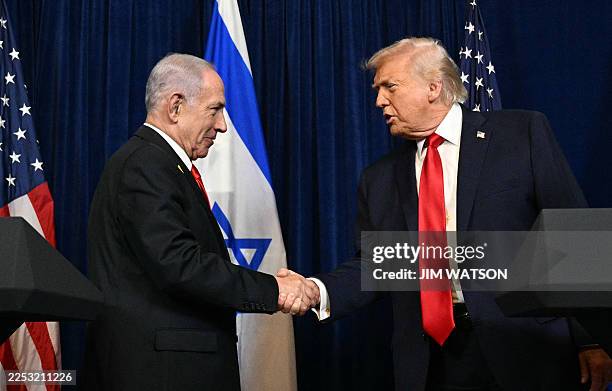 President Donald Trump and Israeli Prime Minister Benjamin Netanyahu shake hands as they arrive to speak to journalists during a joint press...