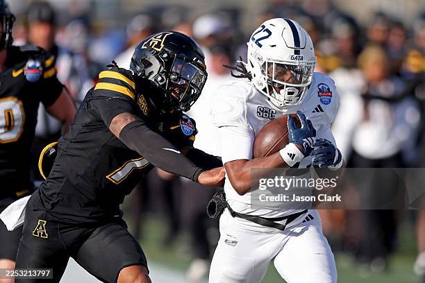 Arnold of the Georgia Southern Eagles is pushed out of bounds by Jordan Favors of the Appalachian State Mountaineers after a first down during the...