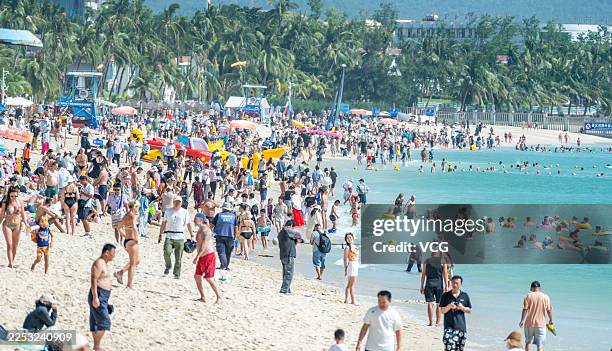 Tourists enjoy leisure time at Dadonghai Tourism Area on December 22, 2025 in Sanya, Hainan Province of China. On December 18 Hainan officially...