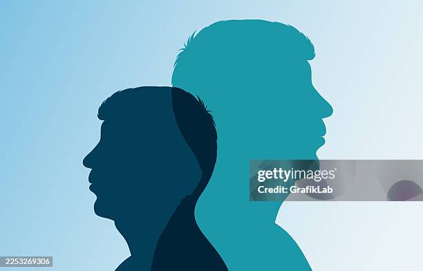 overlapping large and small male silhouettes in blue tones with personal development theme - mindset stock illustrations