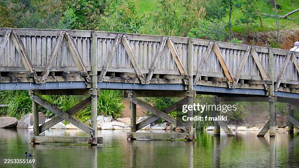 Detail of the timber architecture and cross-bracing of a wooden bridge at Emerald Lake Park