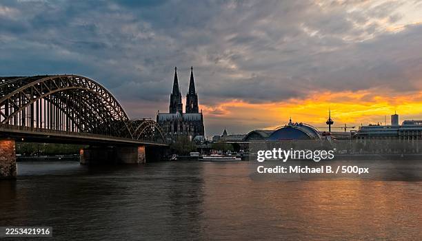 cologne cathedral and hohenzollern bridge at sunset over the rhine river,cologne,germany - rhine river stock pictures, royalty-free photos & images