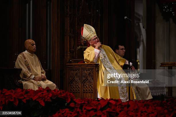 Cardinal Timothy Dolan, outgoing Archbishop of New York, listens during Midnight Mass on Christmas Eve at St. Patrick’s Cathedral on December 24,...