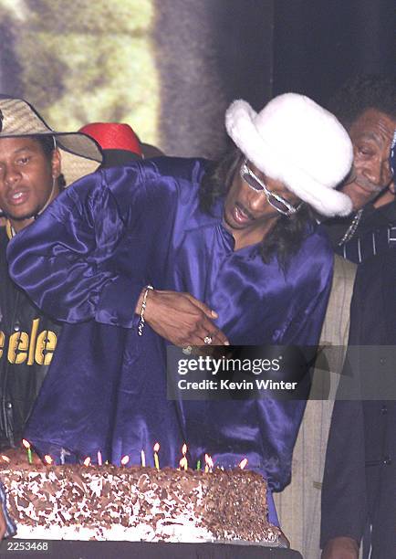 Snoop Dogg blows out the candles on his birthday cake at the House of Blues in Los Angeles. Snoop Dogg celebrated the opening of his film "Bones" and...