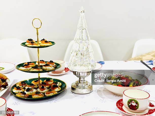 festive christmas table setting with salad and appetisers - christmas party canapes stock pictures, royalty-free photos & images