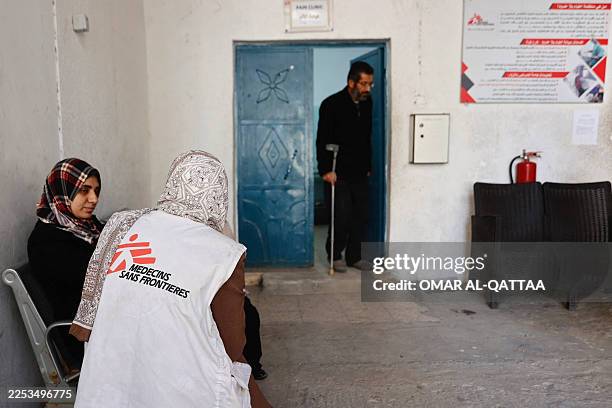 Member of staff at the Doctors Without Borders or Medecins Sans Frontieres speaks to a woman visiting a clinic, in the al-Rimal neighborhood of Gaza...