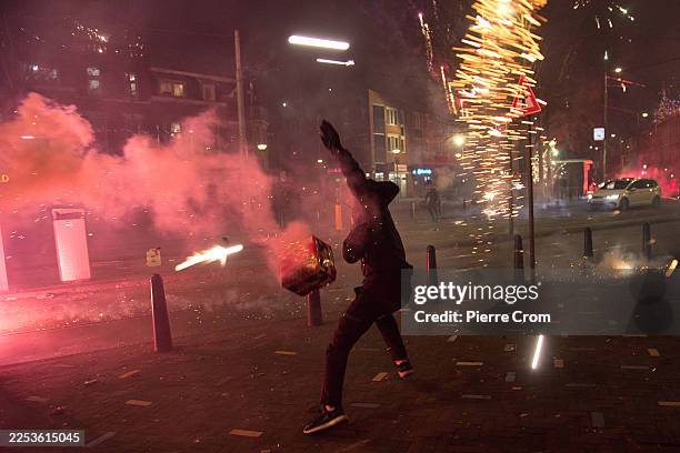 Groups of residents from neighboring streets clash using fireworks in the Transvaal district on January 1, 2026 in The Hague, Netherlands....