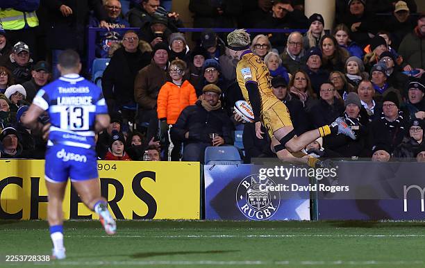 Henry Pollock of Northampton Saints dives to score their fourth try during the Gallagher PREM match between Bath Rugby and Northampton Saints at The...