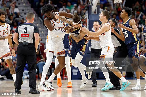 Jose Alvarado of the New Orleans Pelicans gets into a scrum with Mark Williams of the Phoenix Suns during the second half of a game at Smoothie King...