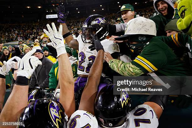 Derrick Henry of the Baltimore Ravens celebrates with teammates after scoring a touchdown in the fourth quarter against the Green Bay Packers at...