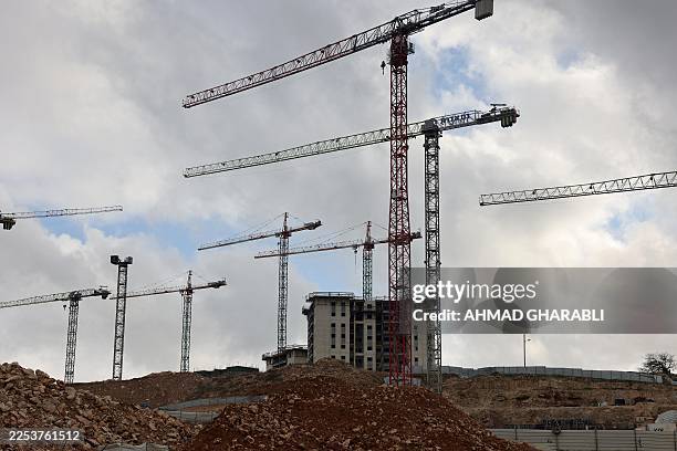 Construction cranes tower above a construction site in Givat HaMatos, an Israeli settlement suburb of Israeli-annexed east Jerusalem on January 2,...