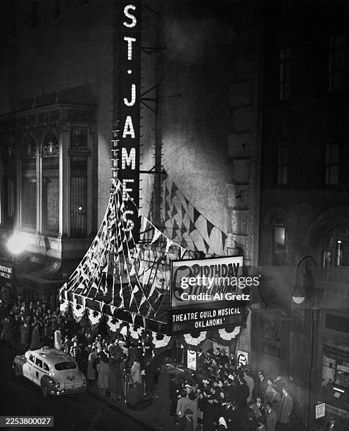 High-angle view of crowds outside the St James Theatre, which is celebrating the fifth anniversary of 'Oklahoma!' on West 44th Street in the Theater...