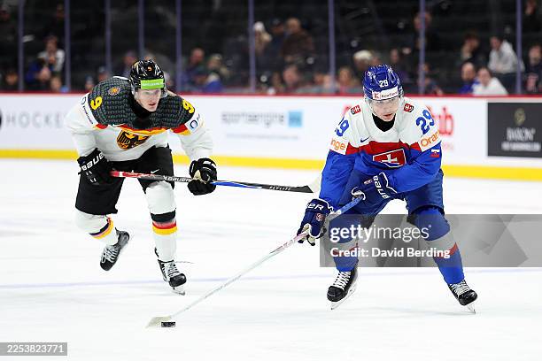 Tomas Chrenko of Slovakia skates with the puck past Elias Pul of Germany in the third period at Grand Casino Arena on December 27, 2025 in St Paul,...