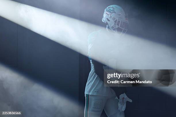 Jeff Wilson Jr. #34 of the Miami Dolphins looks on prior to a game against the Tampa Bay Buccaneers at Hard Rock Stadium on December 28, 2025 in...