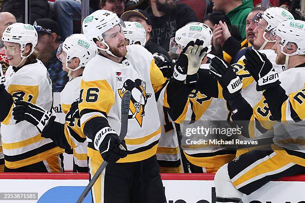 Justin Brazeau of the Pittsburgh Penguins celebrates with teammates after scoring his third goal of the game against the Chicago Blackhawks during...