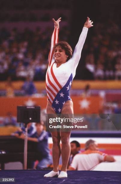 Mary Lou Retton of the United States raises her arms on completion of her Floor routine in the Women's Team All-Around competition on 3rd August 1984...