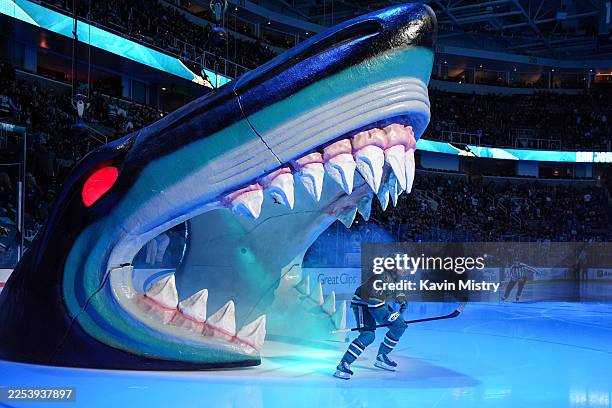 Macklin Celebrini of the San Jose Sharks takes the ice through the Shark Head before the game against the Tampa Bay Lightning at SAP Center on...
