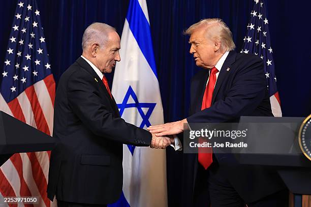 President Donald Trump shakes hands with Israeli Prime Minister Benjamin Netanyahu during a press conference at his Mar-a-Lago club on December 29,...