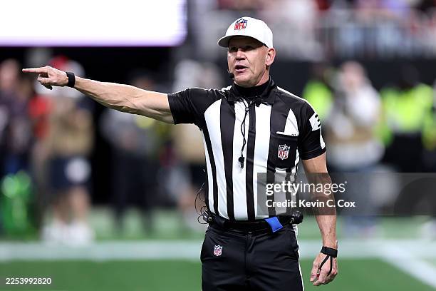 Referee Clete Blakeman announces a penalty between the Atlanta Falcons and the Los Angeles Rams during the third quarter at Mercedes-Benz Stadium on...