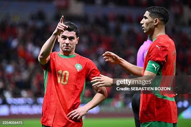 Morocco's forward Brahim Diaz celebrates scoring his team's first goal with Morocco's defender Achraf Hakimi during the Africa Cup of Nations round...