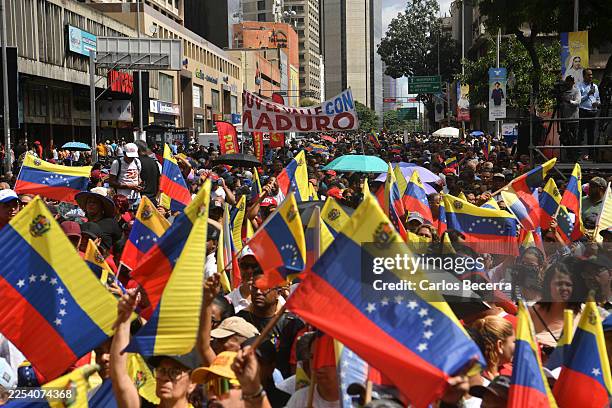 Pro-government supporters attend a rally a day after the capture of Nicolas Maduro by US forces on January 4, 2026 in Caracas, Venezuela. US...
