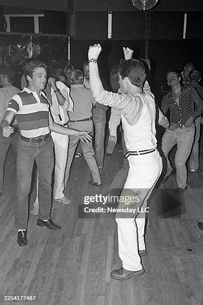 John Colaneri, left, and Tim Doyle dance to disco music at Club Swamp in Wainscott, New York, on July 5, 1979.