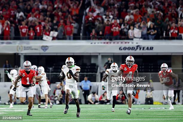 Keionte Scott of the Miami Hurricanes runs for a touchdown after intercepting a pass from Julian Sayin of the Ohio State Buckeyes in the second...
