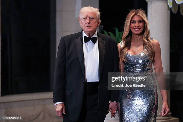 President Donald Trump and first lady Melania Trump arrive for a New Year’s Eve event at his Mar-a-Lago home on December 31, 2025 in Palm Beach,...