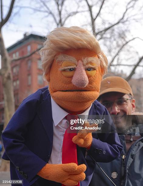 Protester holds a puppet depicting former U.S. President Donald Trump outside the Manhattan Federal Court in New York, United States as...