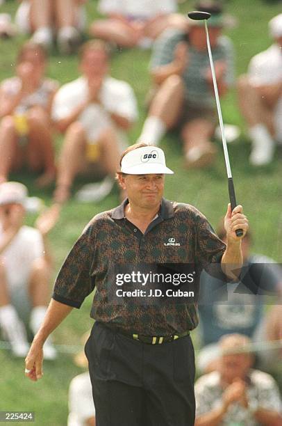 Raymond Floyd pumps his fist after making a birdie putt on the 18th hole during the third round of the 1996 Ford Senior Players Championship at the...