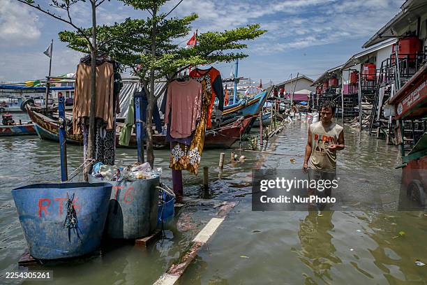 Children play in the water during tidal flooding in the Muara Angke area in Jakarta, Indonesia, on January 6, 2026. The Jakarta Provincial Government...