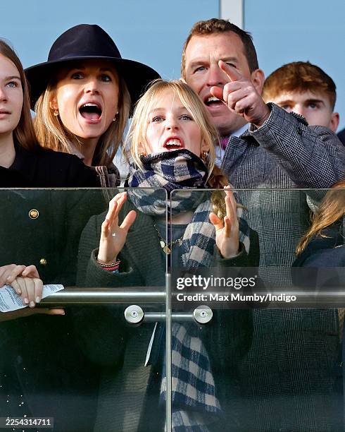 Harriet Sperling, Isla Phillips and Peter Phillips watch the racing as they attend the New Year's Day Racing Meet at Cheltenham Racecourse on January...