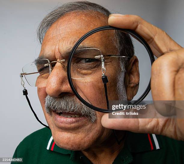 close-up of old detective looking through magnifying glass - see through stock pictures, royalty-free photos & images