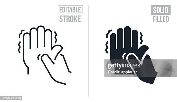 person rubbing their arthritic hand with their other hand - editable stroke and solid icons - parkinsons disease stock illustrations