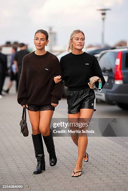 Guest is seen wearing an oversized brown mohair knit sweater with dropped shoulders and logo detail at the chest from Rotate; black satin shorts with...