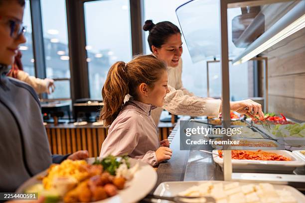 family and friends enjoying buffet breakfast at a modern café with fresh dishes - buffet stockfoto's en -beelden