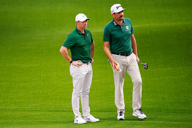 Rory McIlroy of Boston Common Golf talks with Keegan Bradley while playing the third hole at SoFi Center on January 02, 2026 in Palm Beach Gardens,...