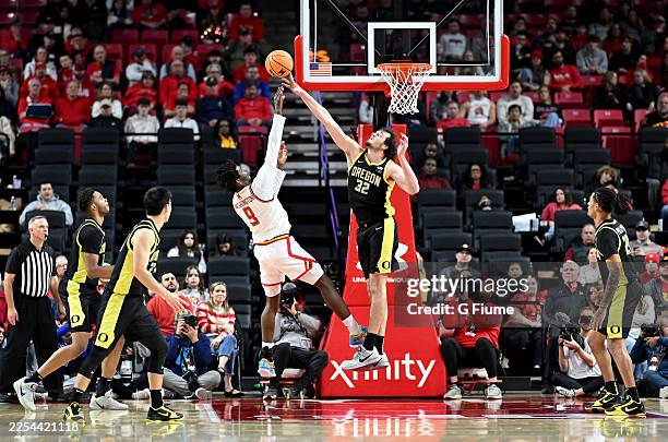 Nate Bittle of the Oregon Ducks blocks a shot attempt by Solomon Washington of the Maryland Terrapins in the second half at Xfinity Center on January...