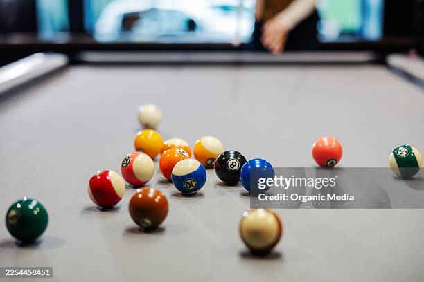pool table with billiard balls and person playing - pool cue stock pictures, royalty-free photos & images