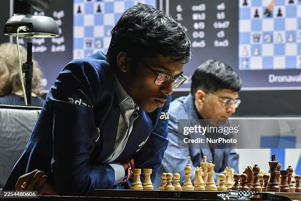 Grandmaster Rameshbabu Praggnanadhaa and World champion Viswanathan Anand are seen during the rapid round of the Tata Steel chess championship in...