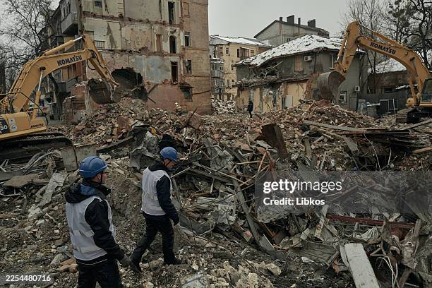 Ukrainian emergency service workers continue emergency and rescue operations at the site of a Russian missile strike in the central part of Kharkiv,...