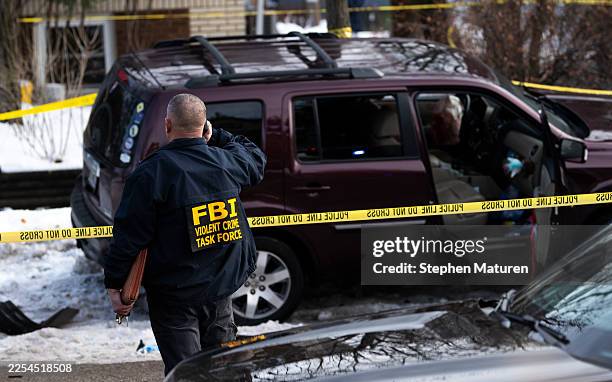 Members of law enforcement work the scene following a suspected shooting by an ICE agent during federal law enforcement operations on January 07,...
