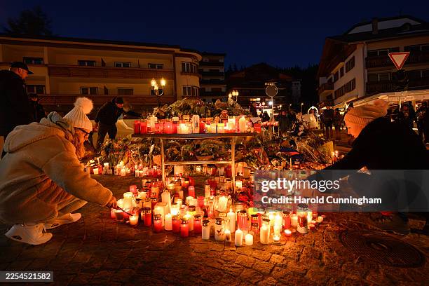 Mourners light candles as the investigation continues into the deadly New Year's Eve fire at Le Constellation bar on January 03, 2026 in...