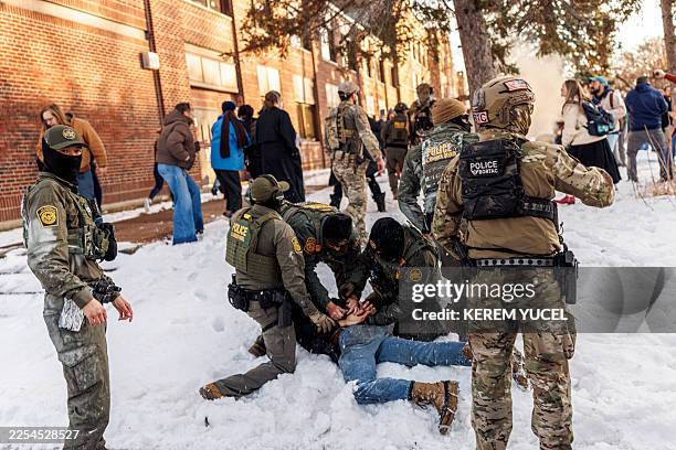 Border Patrol agents detain a person near Roosevelt High School during dismissal time as federal immigration enforcement actions sparked protests in...