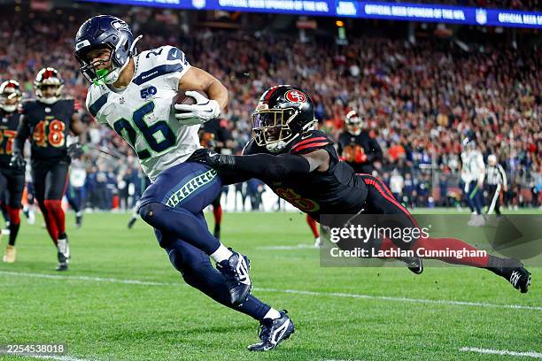 Zach Charbonnet of the Seattle Seahawks scores a touchdown against Malik Mustapha of the San Francisco 49ers during the first quarter of a game at...