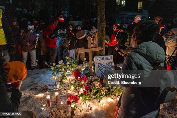 Community members pray during a vigil following a fatal shooting by an Immigration and Customs Enforcement agent in Minneapolis, Minnesota, US, on...