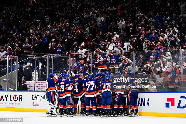The New York Islanders celebrate an overtime game-winning goal scored by Matthew Schaefer against the Toronto Maple Leafs at UBS Arena on January 3,...