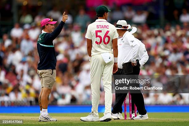 Groundskeeper signals for the covers as a light delay is called during day one of the Fifth Test in the 2025/26 Ashes Series between Australia and...